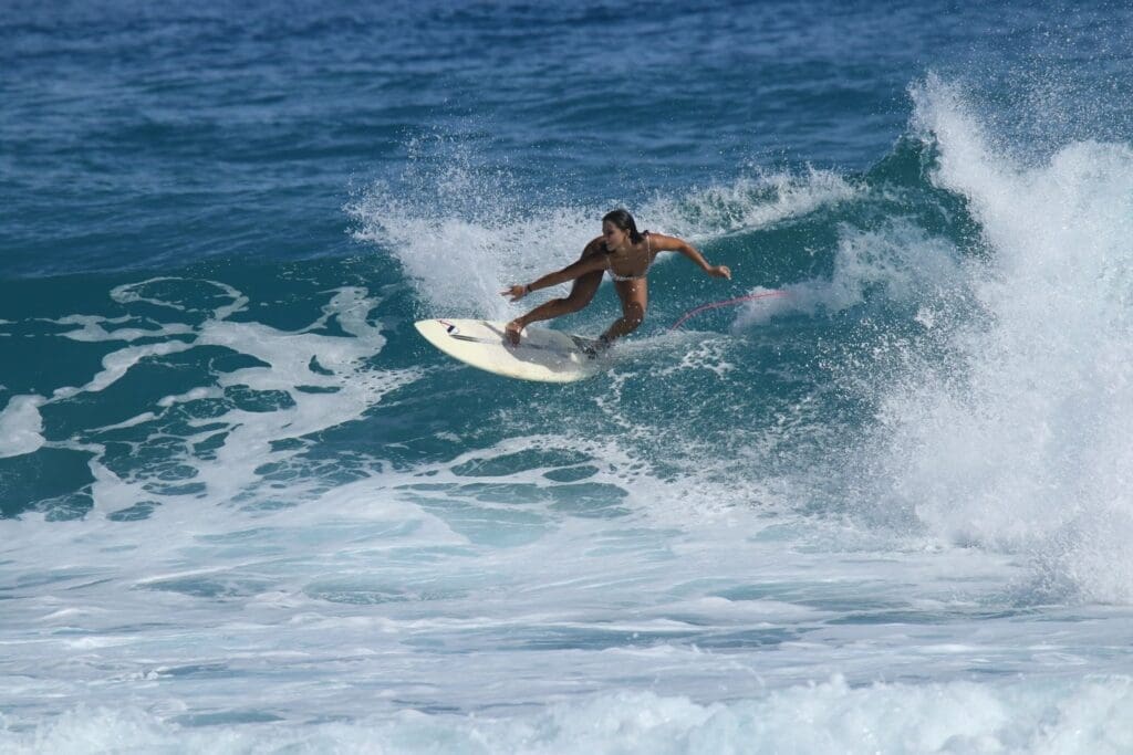 Woman surfing at Encuentro Beach in Cabarete, Dominican Republic
